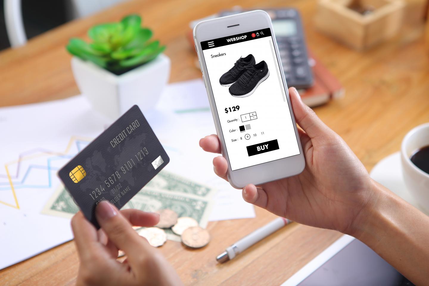 Image of credit card, online store on smartphone